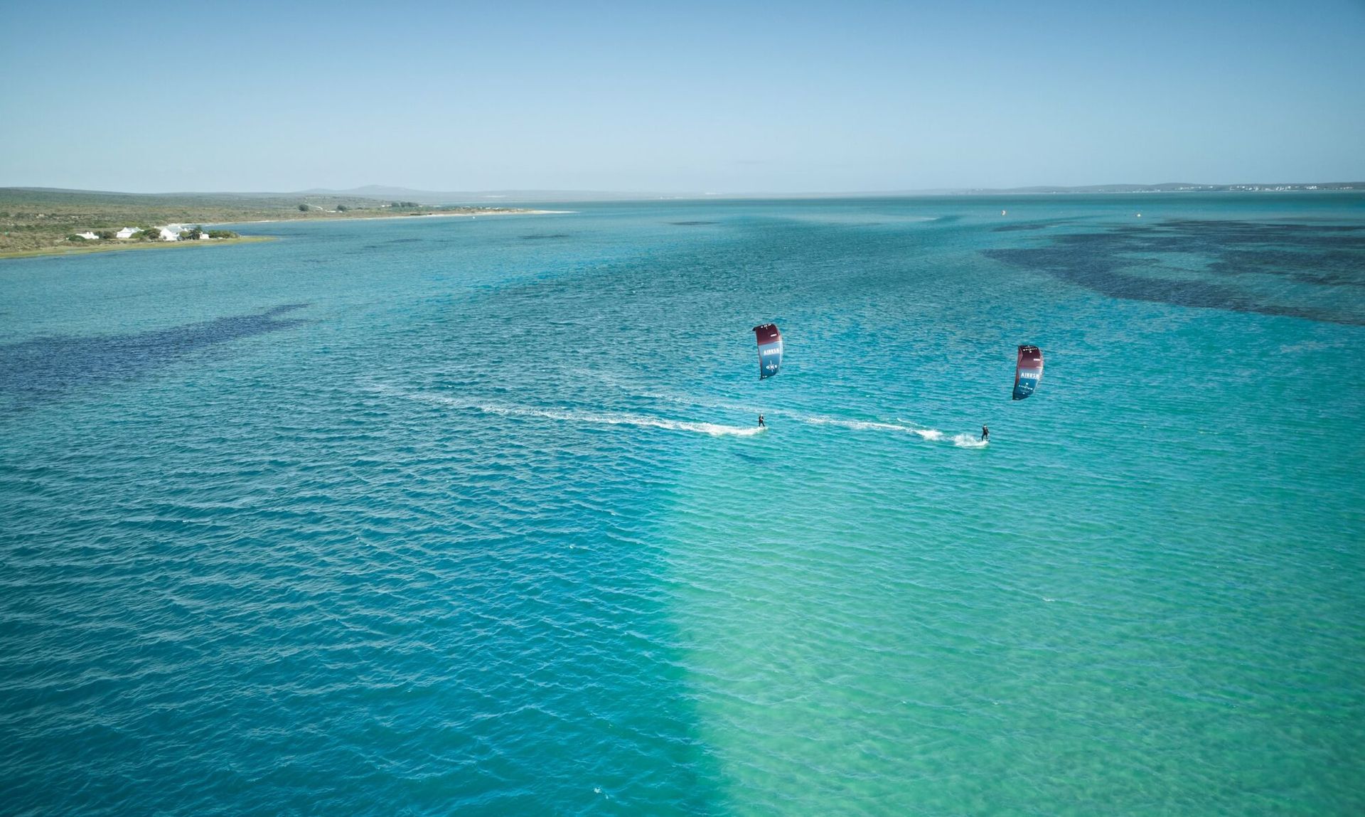 Aerial view of kitesurfers on the turquoise Langebaan lagoon, South Africa