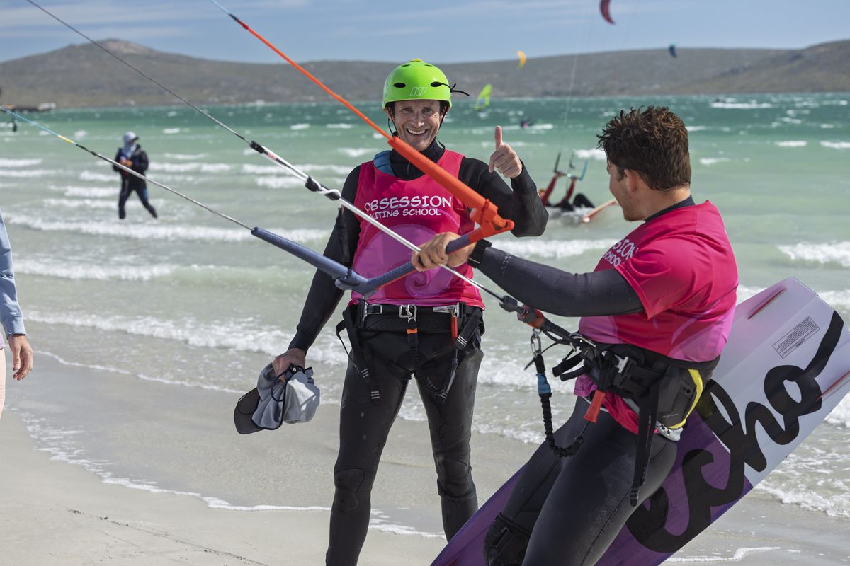 Obsession Kiting instructor teaching a student to fly a kite on Langebaan beach
